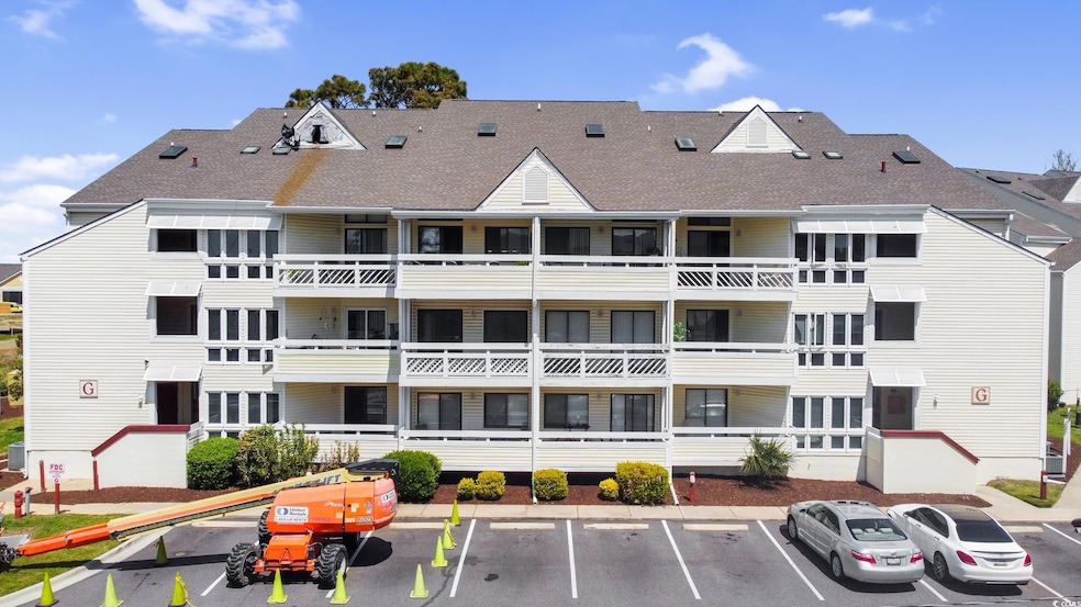 View of building exterior with uncovered parking