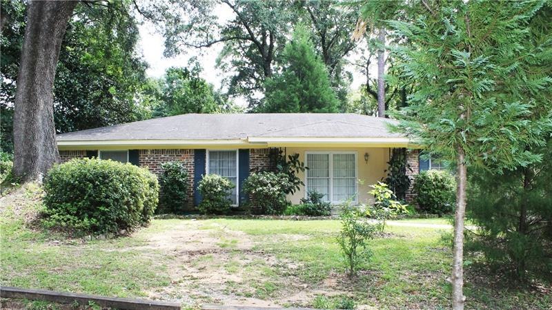 This tree shaded comfortable brick home is about t