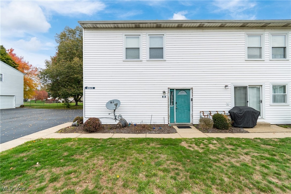Traditional-style condominium with a front lawn