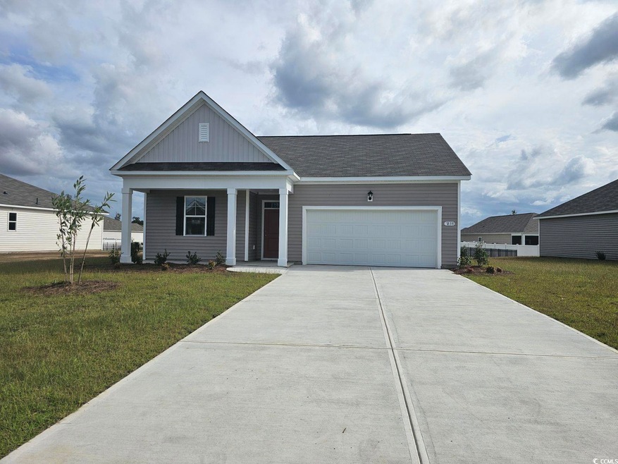 View of front facade featuring a porch, a garage, 