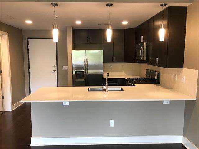 Kitchen with stone quartz counter, bar w/room for 