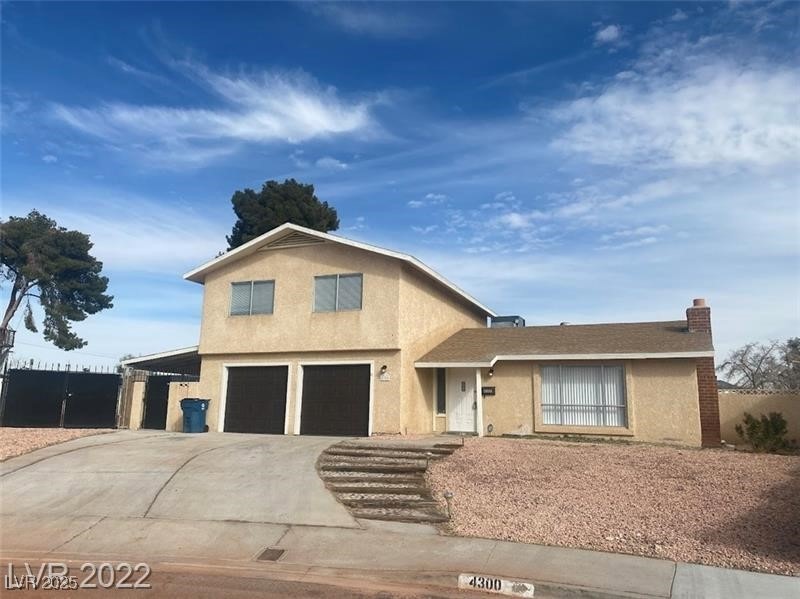 View of front of home with a garage, driveway, and