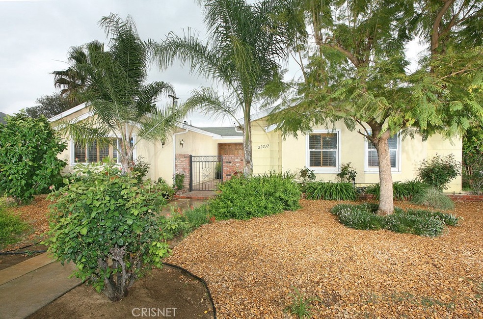 Its professional drought resistant landscaping, mature shade trees, swaying palms, sweeping brick walkway, and fenced courtyard entry enhance its eye-catching curb appeal.