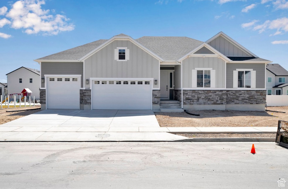 Craftsman inspired home with board and batten siding, stone siding, concrete driveway, and a shingled roof