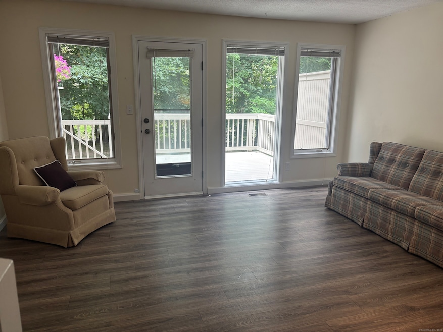Living Room - Spacious and bright with convenient view of and access to rear, private Deck.
