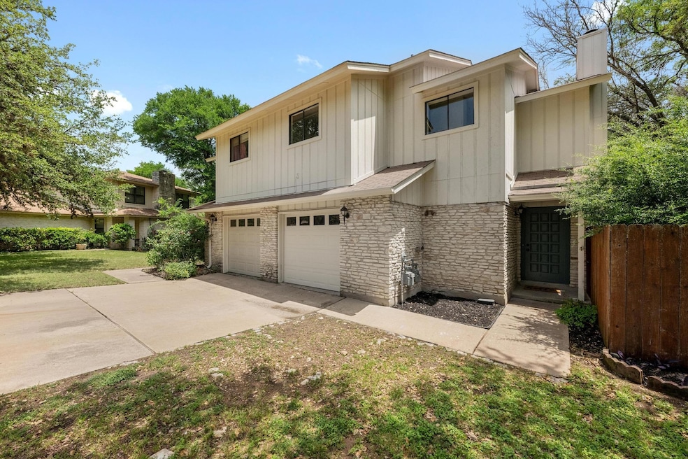 View of front facade featuring fence, concrete dr