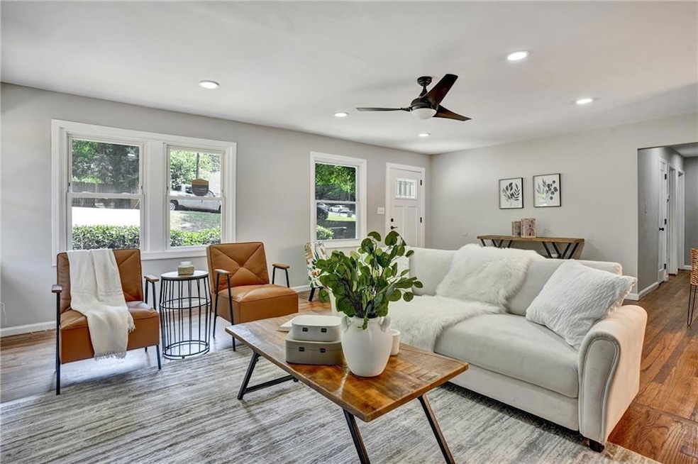 Living room with ceiling fan and wood-type floorin