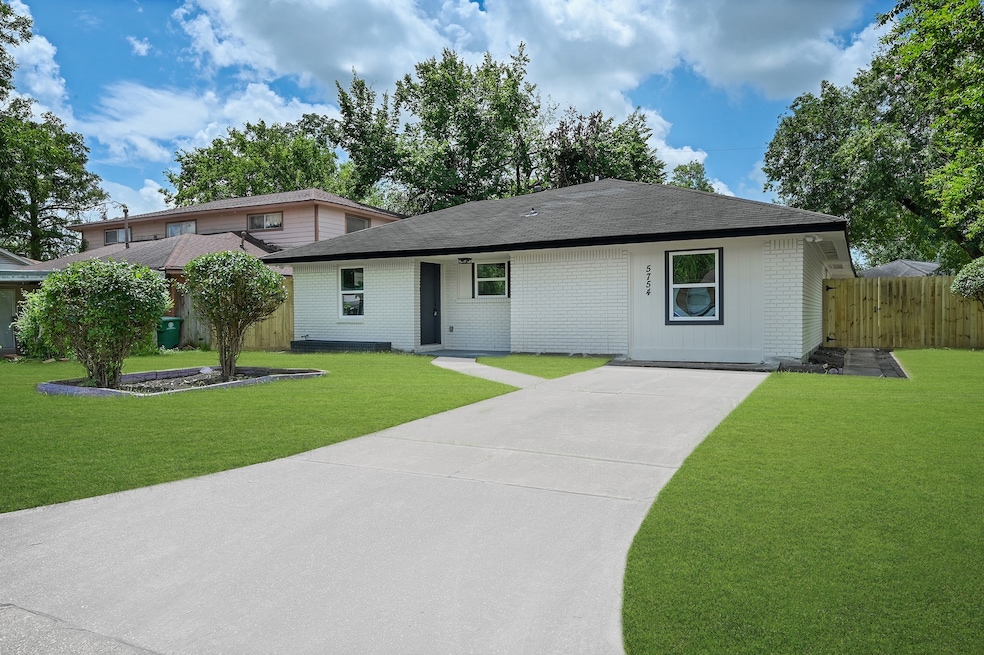 Spacious driveway and well manicured lawn.