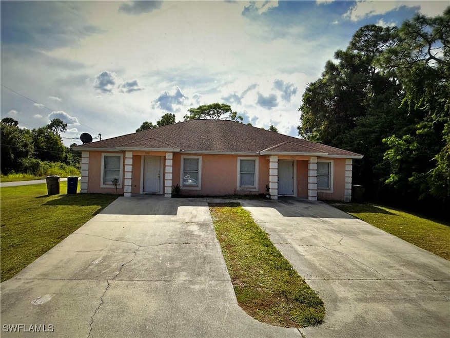 View of front of property featuring driveway and a