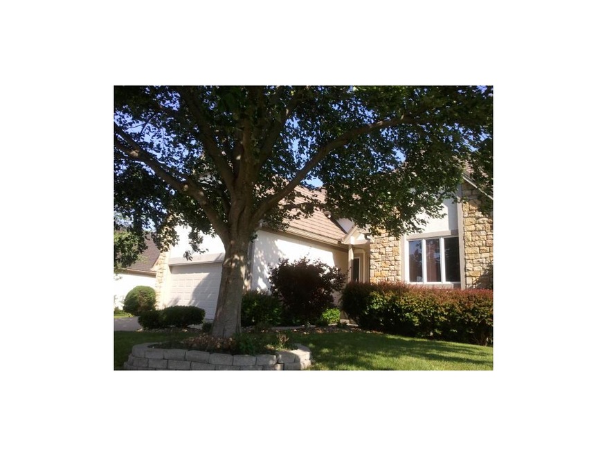 Stone front home overlooks golf course