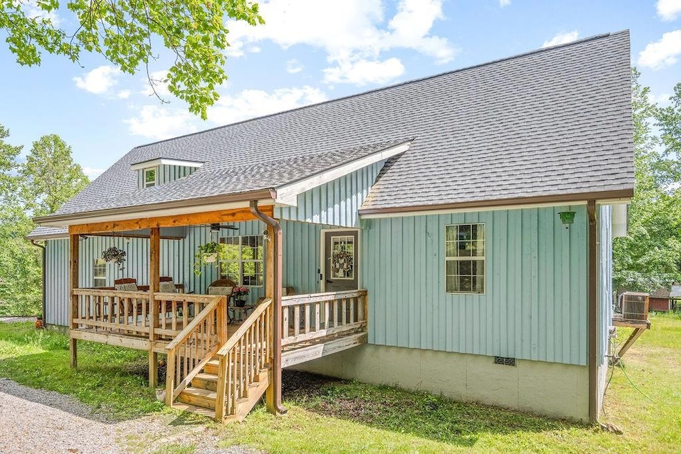 Rear view of house featuring roof with shingles, b