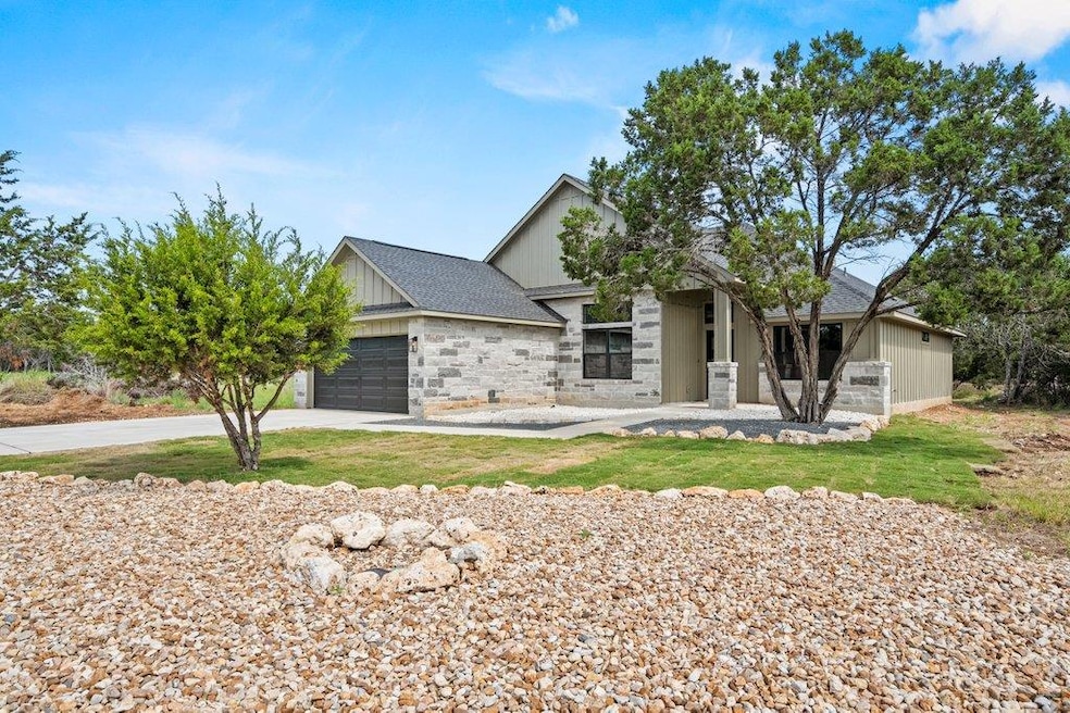 View of front of home with an attached garage, st