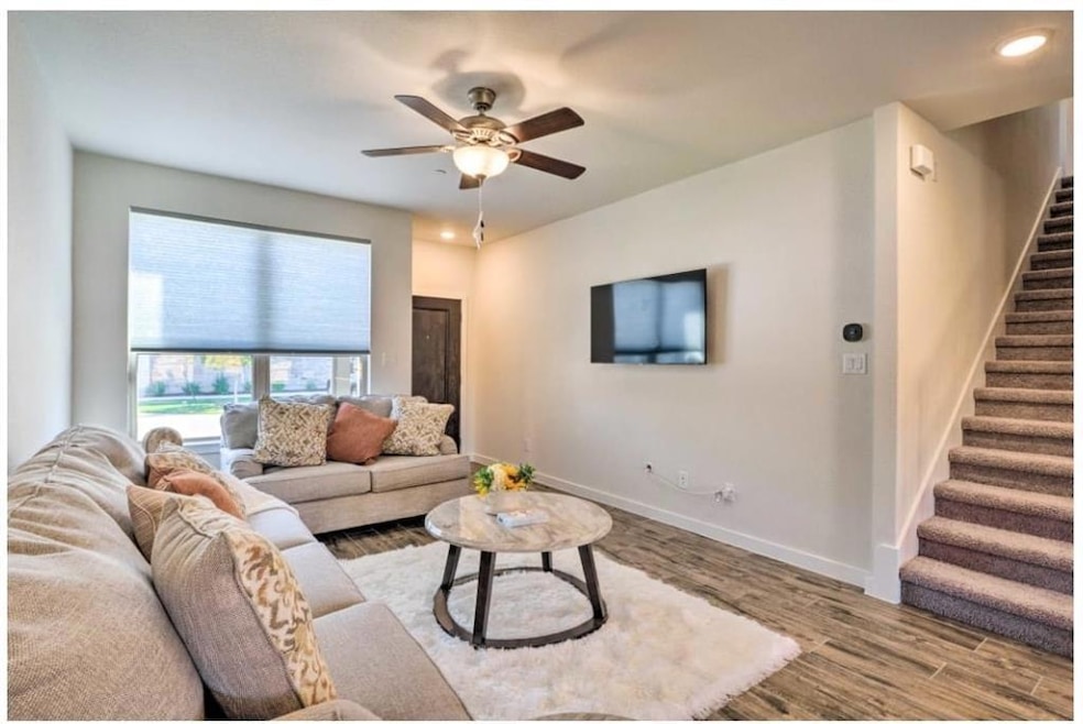 Living room featuring stairway, wood finished flo