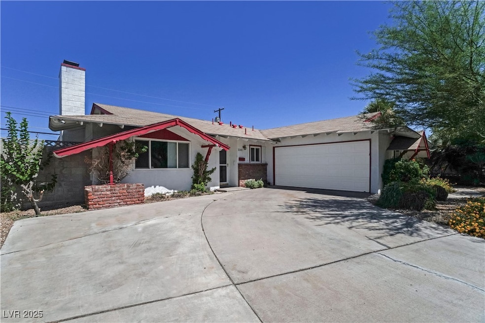 Single story home with concrete driveway, a garage