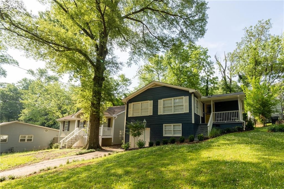 Tri-level home with a front lawn, stairs, and a porch
