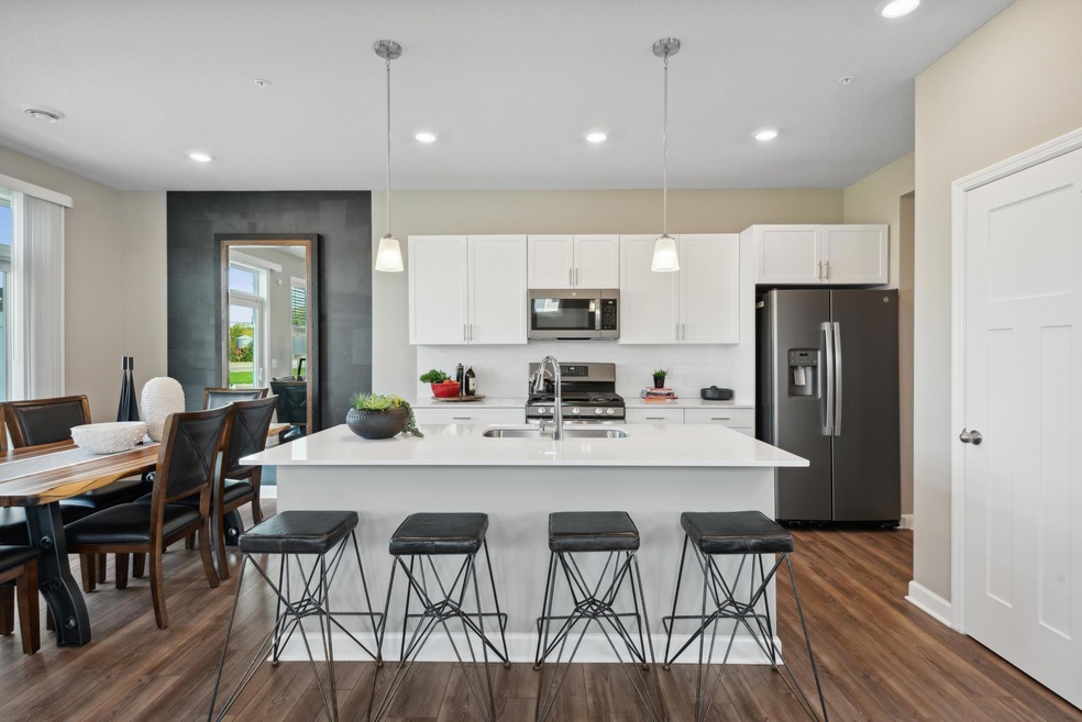 Welcome to the Raleigh! A Spacious kitchen and dinette with convenient sliding glass door. *Photos of model home; colors and finishes will vary.