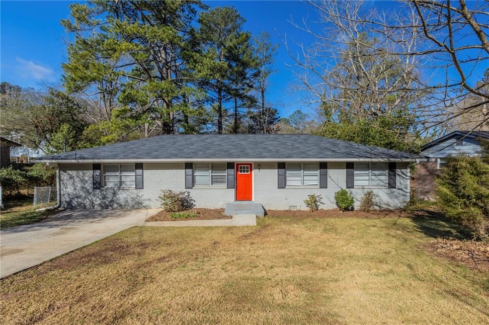 Ranch-style house with driveway, roof with shingles, crawl space, a front lawn, and brick siding