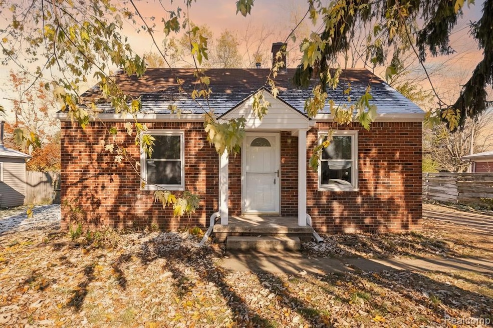 Bungalow-style house with brick siding and roof with shingles