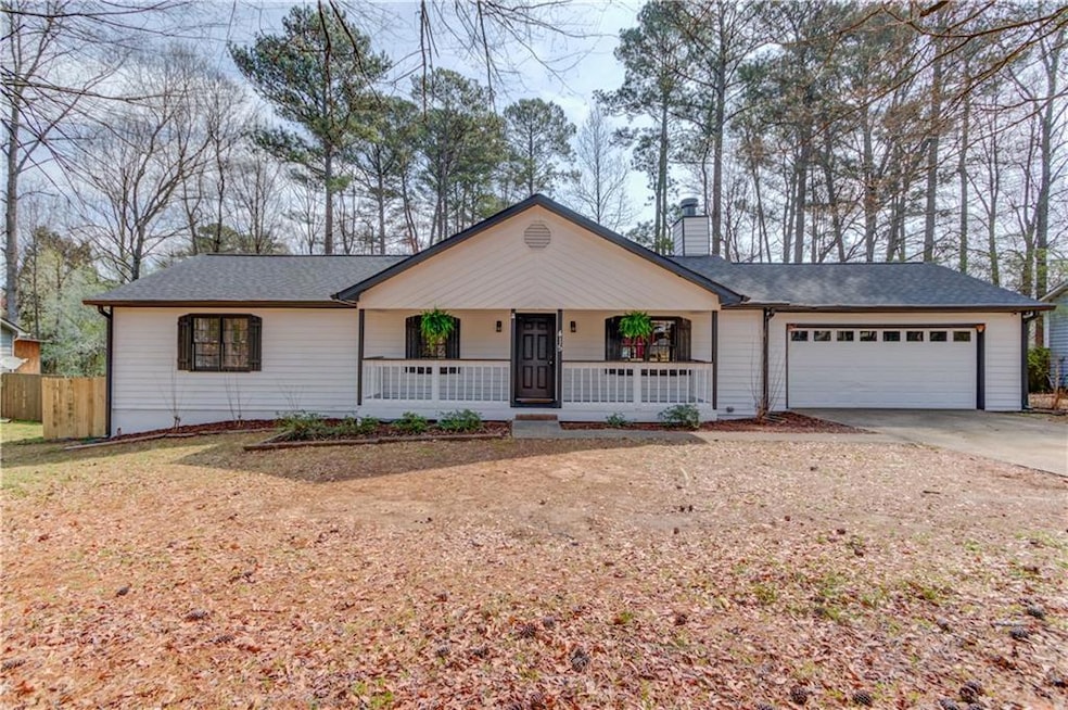 Ranch-style home with a porch, an attached garage,