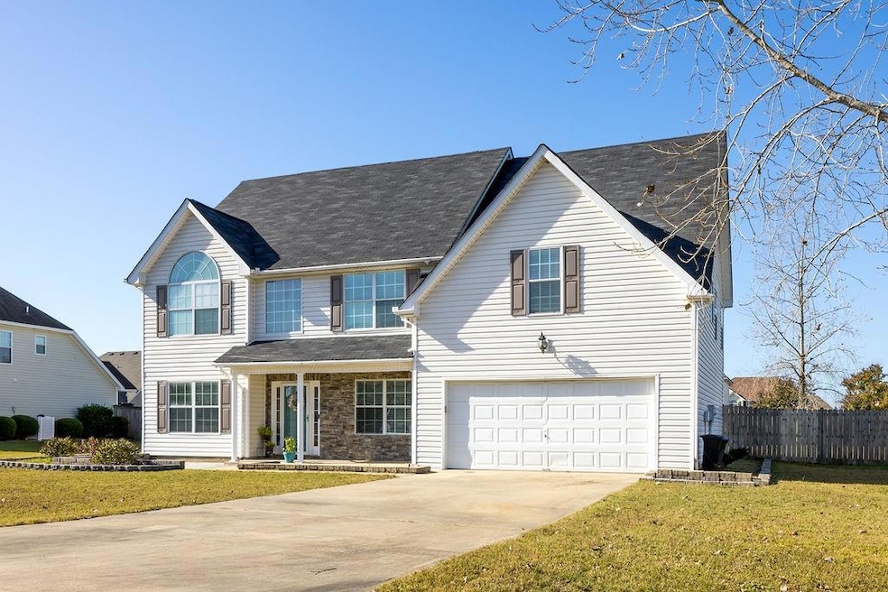 View of front of home with a garage and a front la