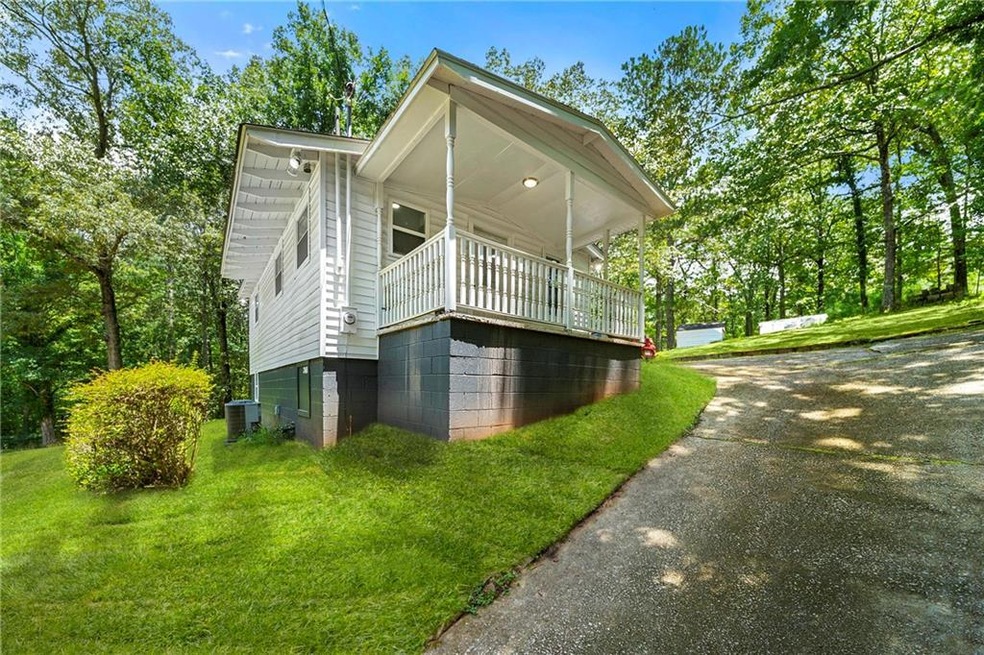 View of side of property with a yard and driveway