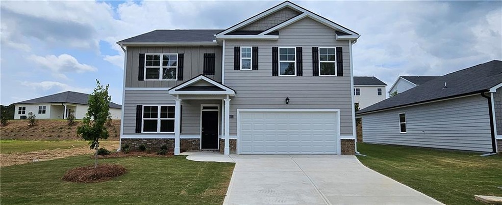 Craftsman house with a garage and a front yard