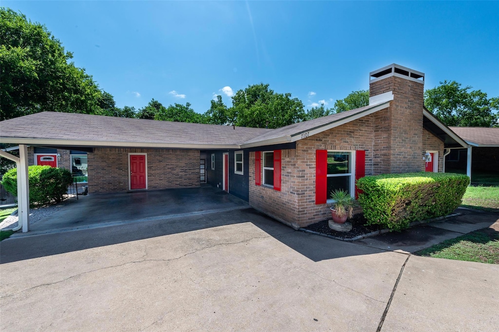 Ranch-style home featuring a chimney, brick sidin