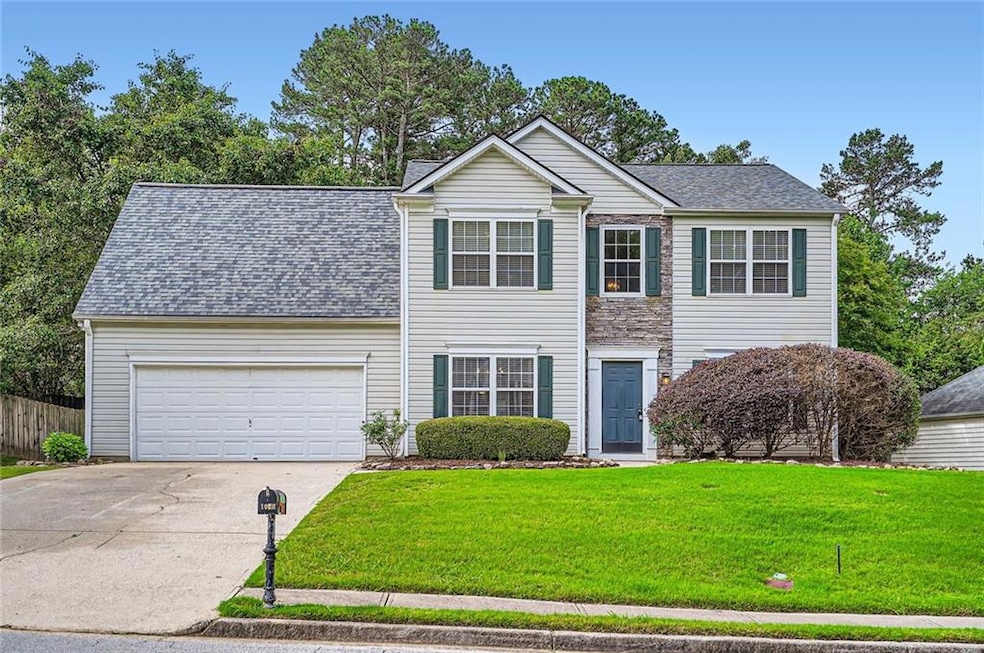 Traditional-style home featuring driveway, an atta