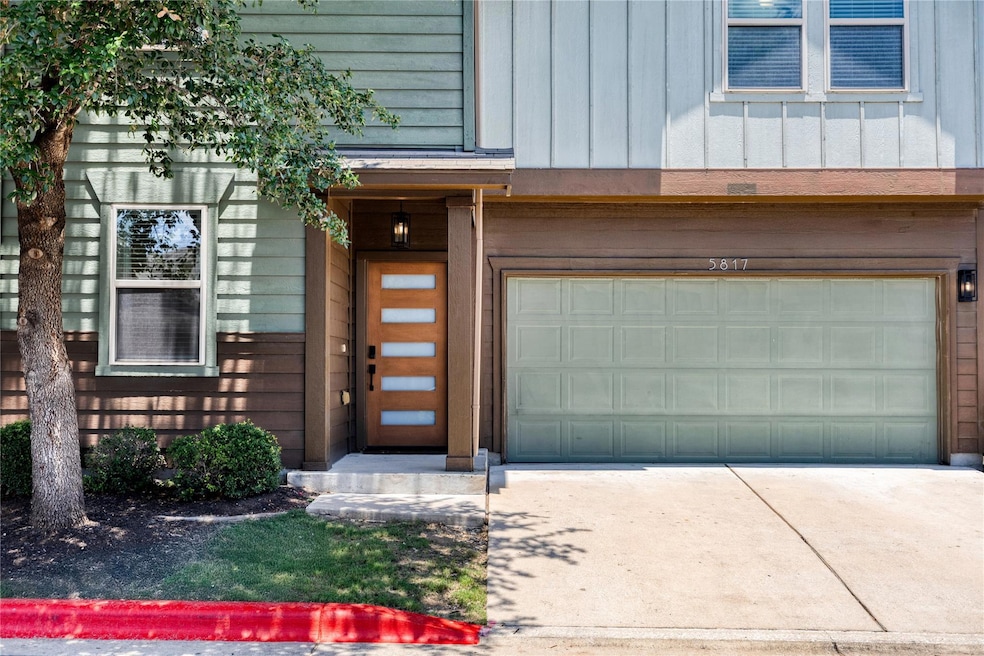 Entrance to property featuring a garage, driveway