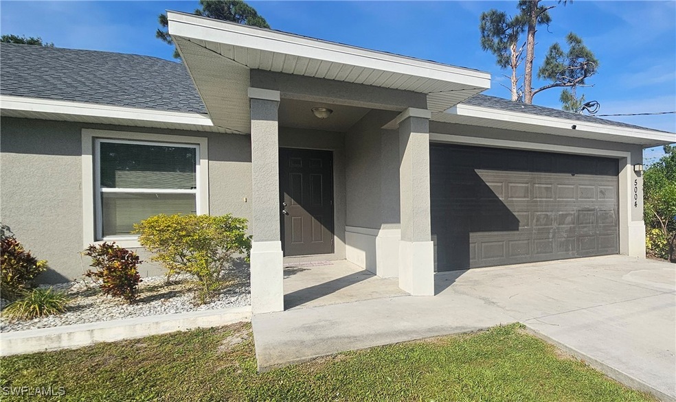 Entrance to property with stucco siding, a shingle