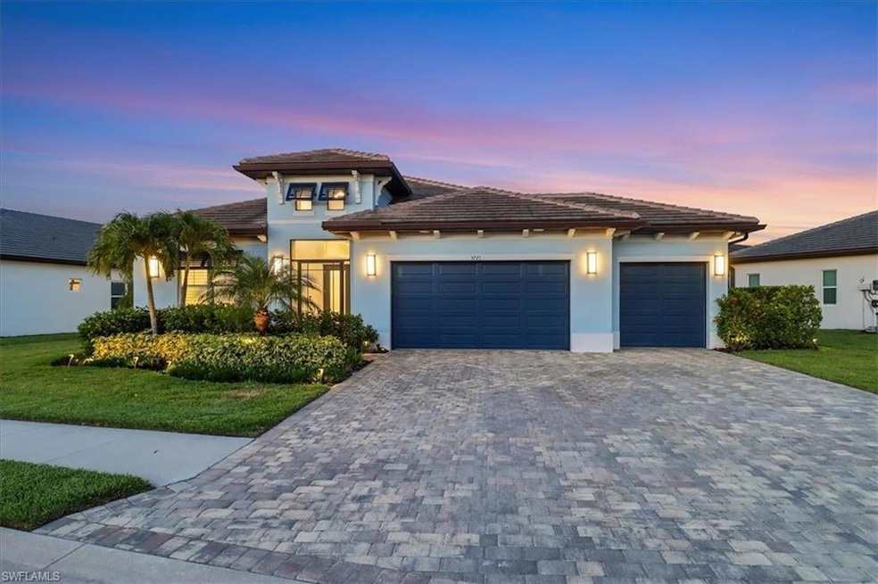 Prairie-style home featuring an attached garage, decorative driveway, stucco siding, a lawn, and a tile roof