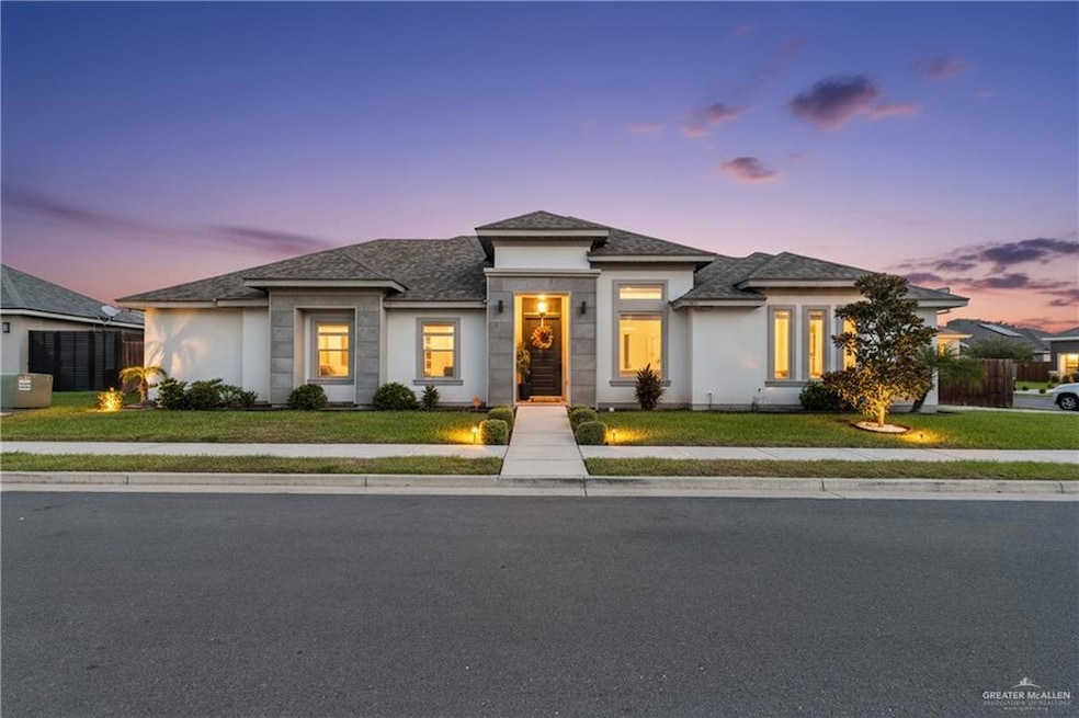 Prairie-style home featuring stucco siding and a shingled roof
