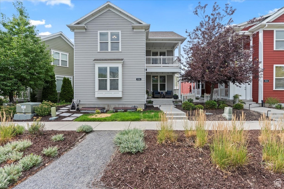 View of front of home with a porch and a balcony