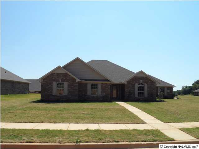 Raleigh Plan D. Plan designed for a corner lot. All brick - 3 car garage.