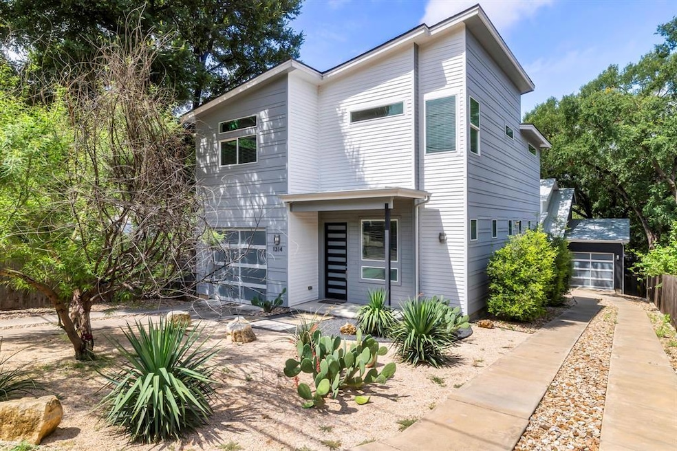 Modern home featuring fence and driveway