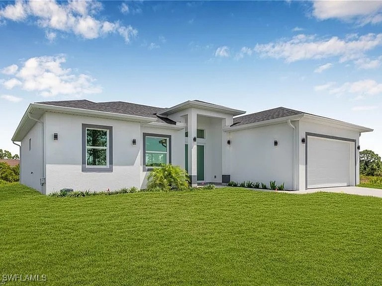 Prairie-style home featuring stucco siding, a gara