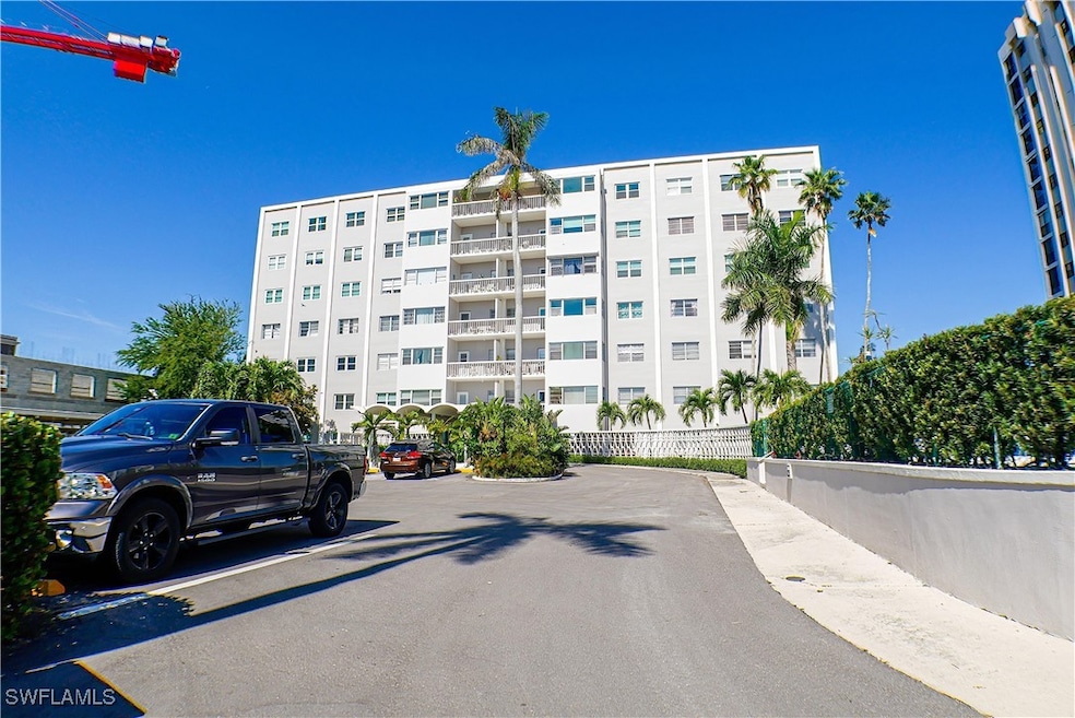View of property with uncovered parking and fence