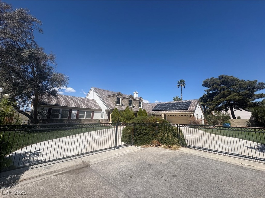 View of front of house with a gate, fence, solar p