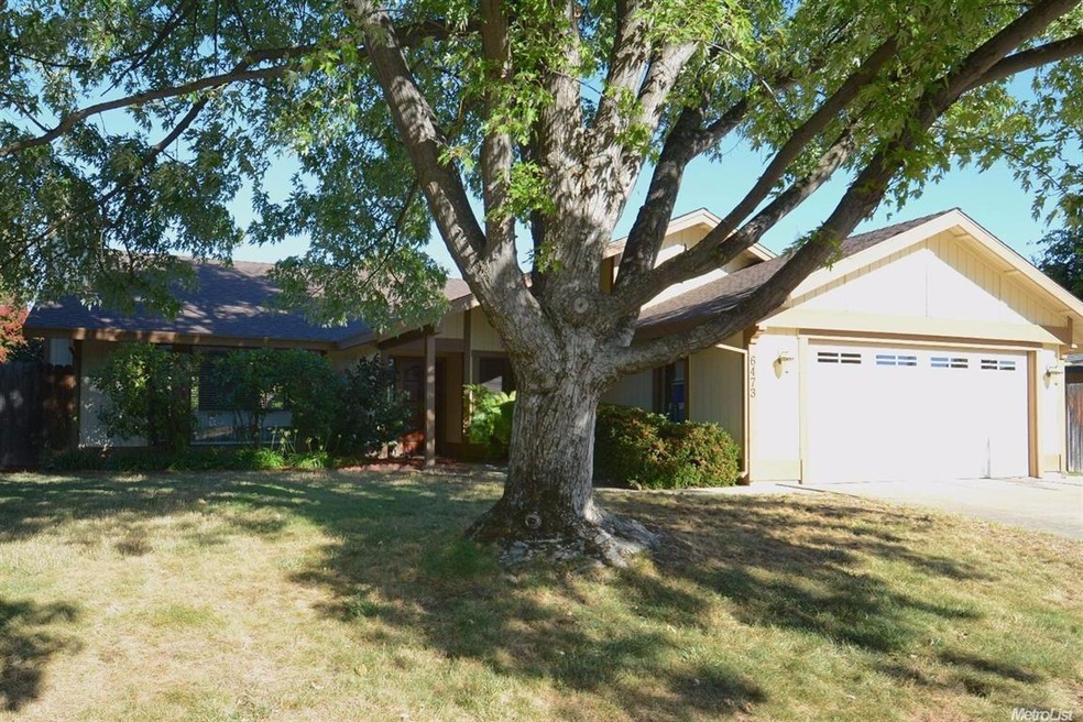 Front of home with beautiful shade tree.