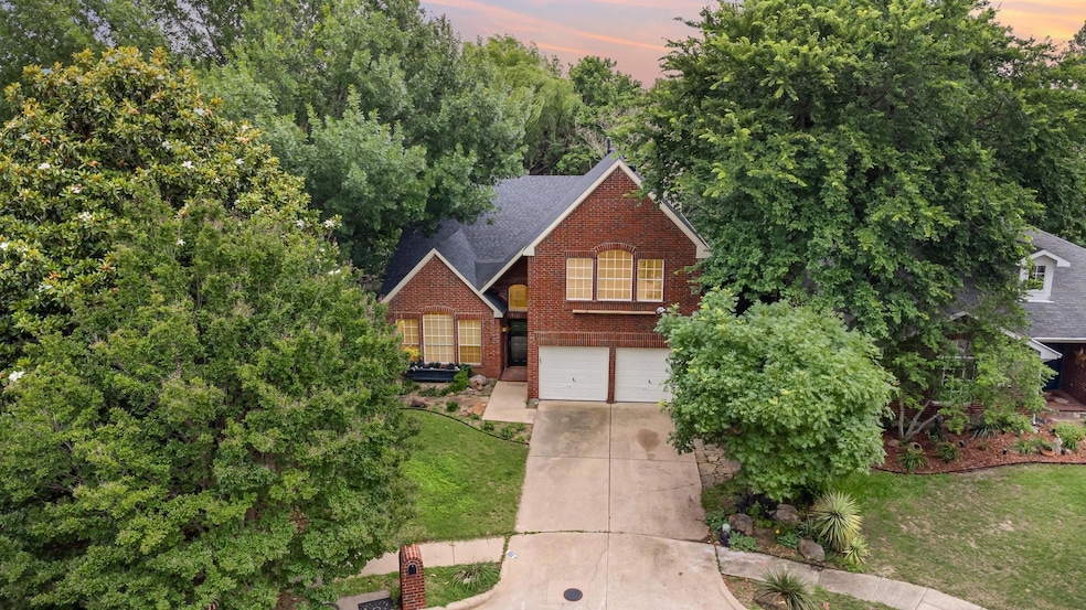 View of front of house with a yard and a garage