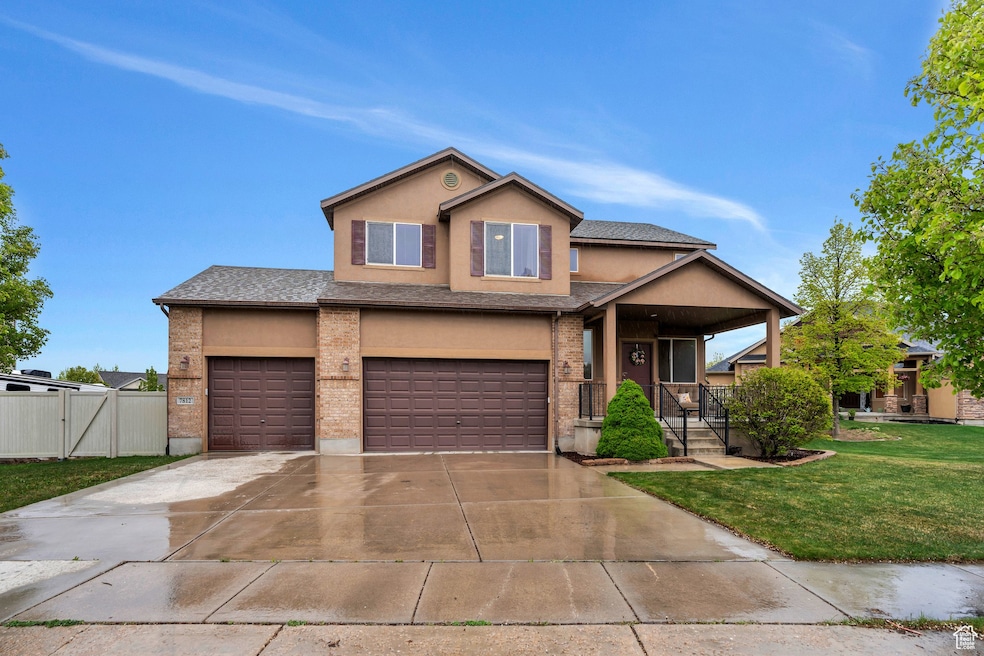 Craftsman inspired home featuring a porch, a gate, a front lawn, concrete driveway, and stucco siding