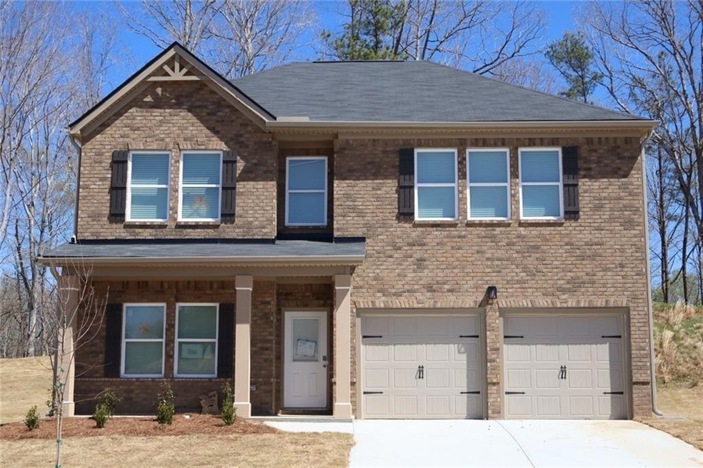 View of front of house featuring roof with shingles, a garage, concrete driveway, and brick siding