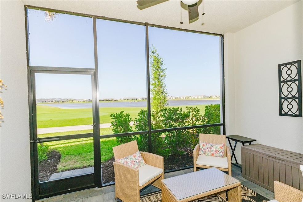 Sunroom / solarium featuring a water view, ceiling fan, and radiator heating unit