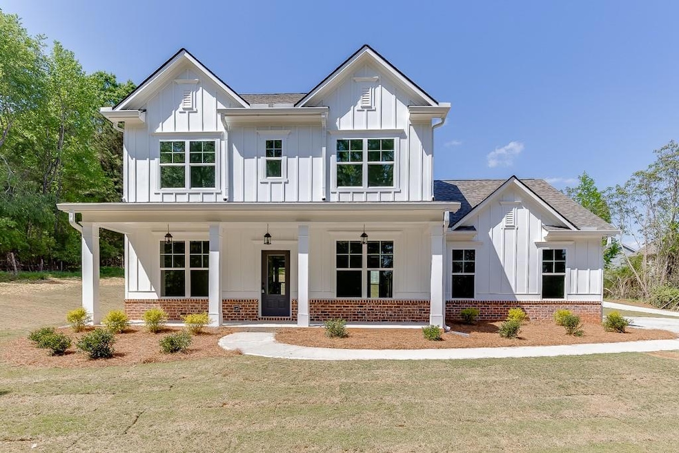 Modern farmhouse style home with a front lawn, bri