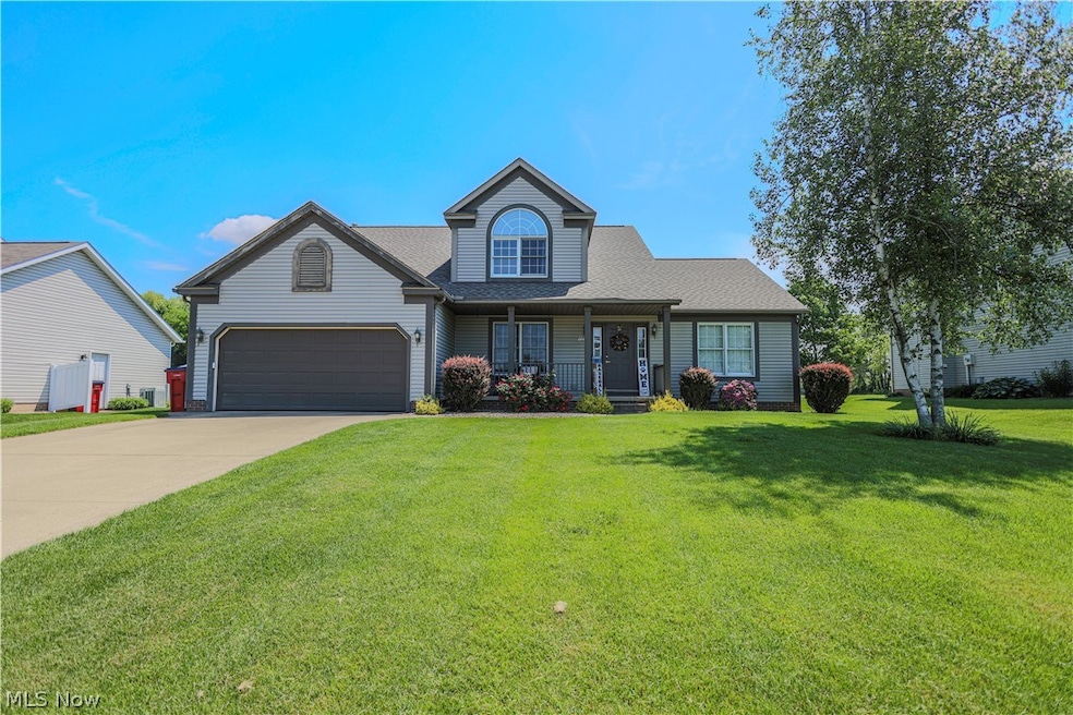 View of front of home with a front lawn and a garage