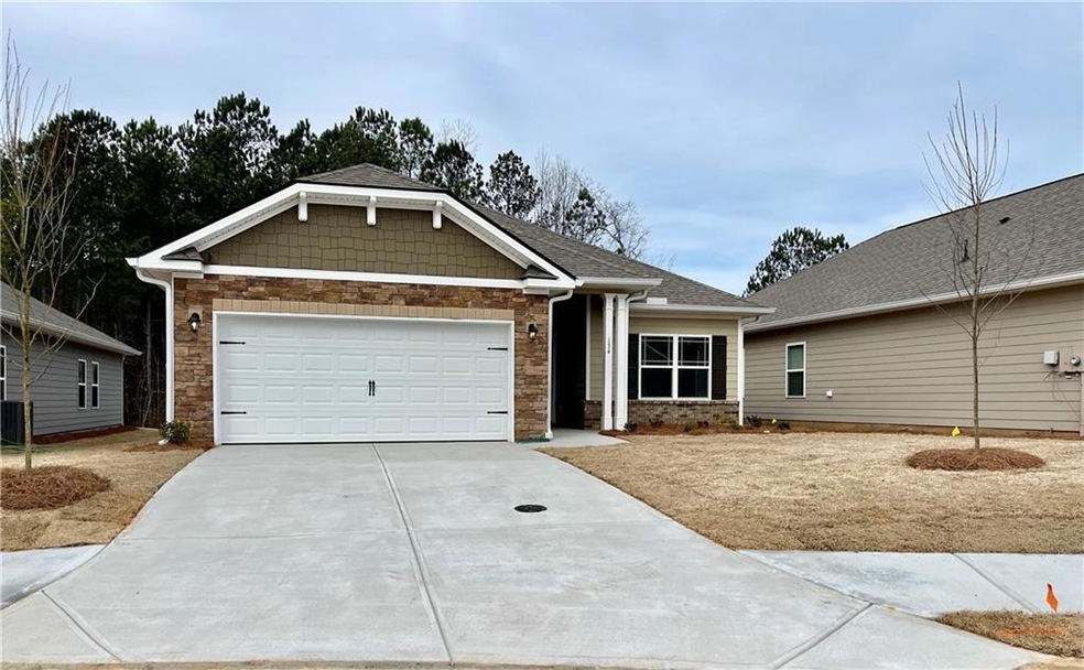 View of front of house with a garage and central a