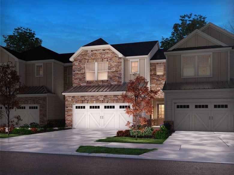 Townhome / multi-family property featuring a garag