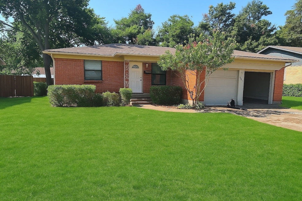 Single story home featuring brick siding, driveway, and an attached garage