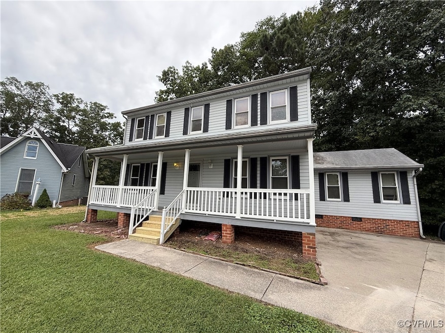 View of front of home with a porch and a front law