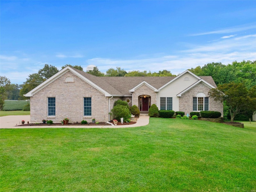 Custom ranch nestled on 3 acres backing to woods o